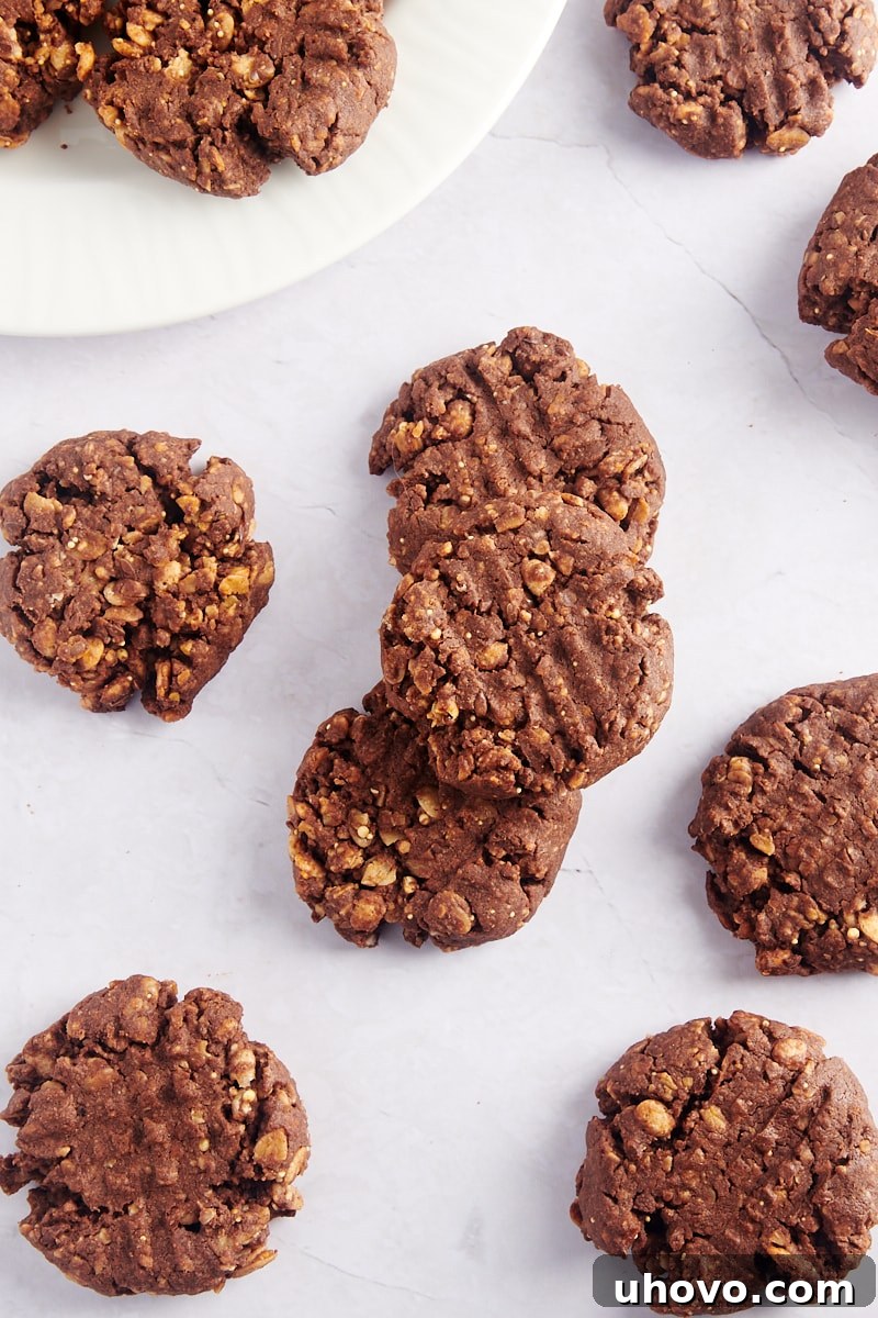 Overhead view of freshly baked chocolate peanut butter granola cookies cooling on a wire rack and arranged on a plate, ready to be enjoyed.