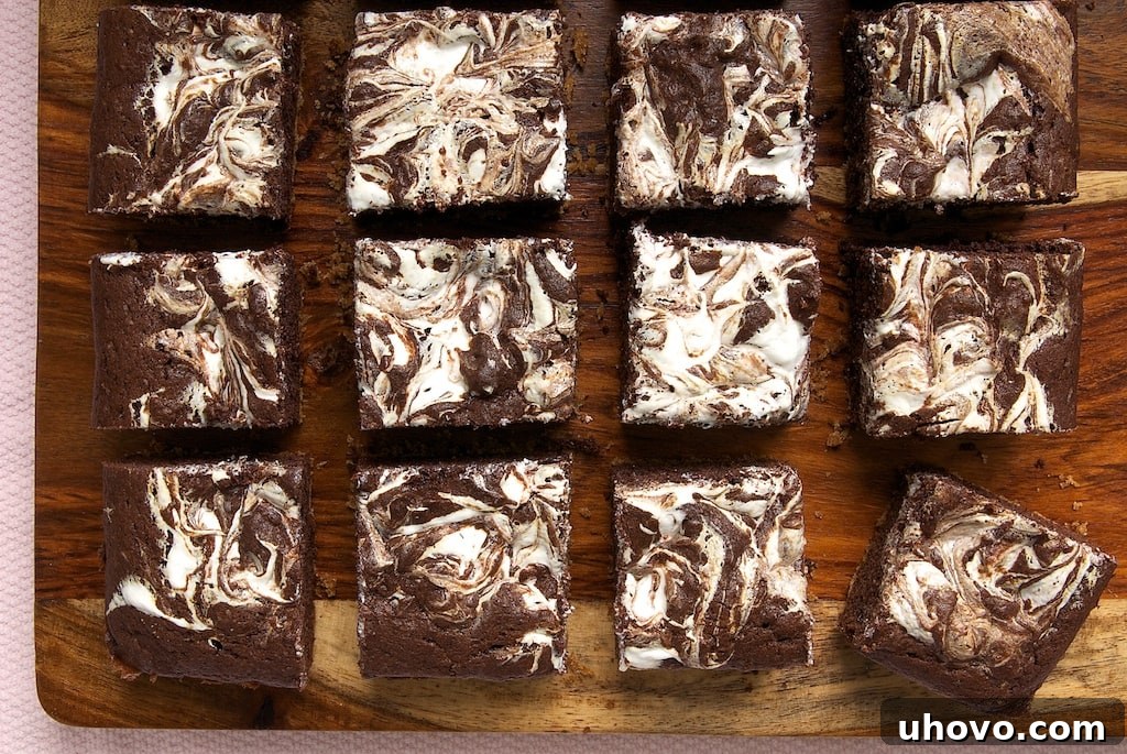 Delicious S'mores Swirl Brownies with a graham cracker crust and gooey marshmallow swirls.