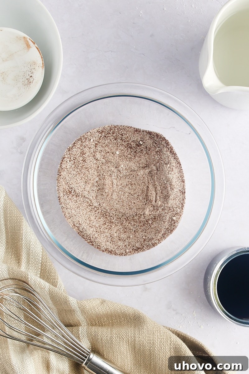 Overhead view of the dry coffee mixture ingredients (sugar and espresso powder) in a bowl.
