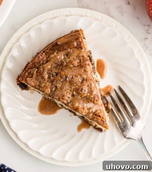 Overhead view of apple streusel coffee cake on plate with fork, showing a generous slice ready to eat