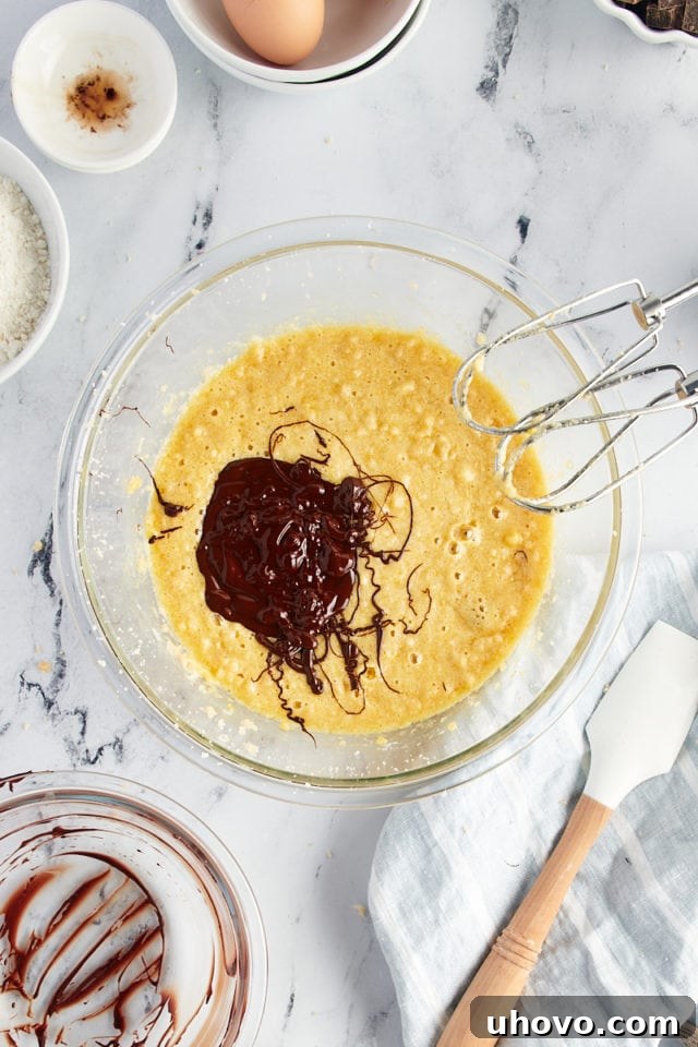 Overhead view of melted chocolate added to wet ingredients