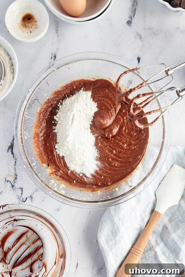 Overhead view of dry ingredients added to brownie batter