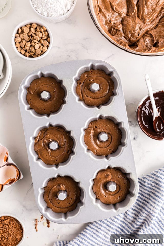 mini bundt pan partially filled with chocolate cake batter