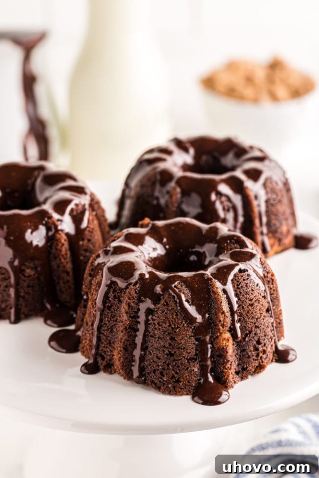 three Mini Chocolate Bundt Cakes on a white pedestal