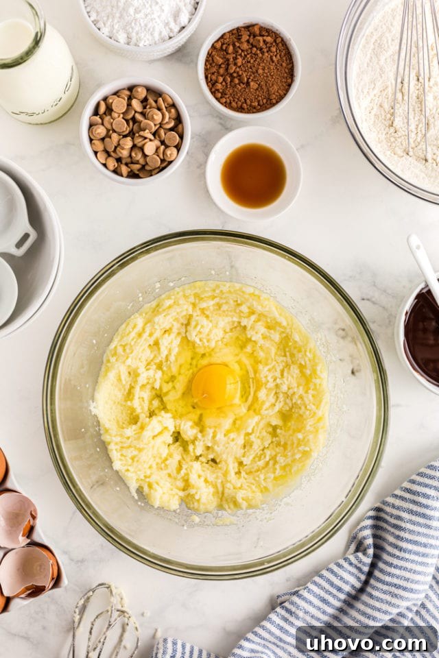 overhead shot of egg added to cake batter