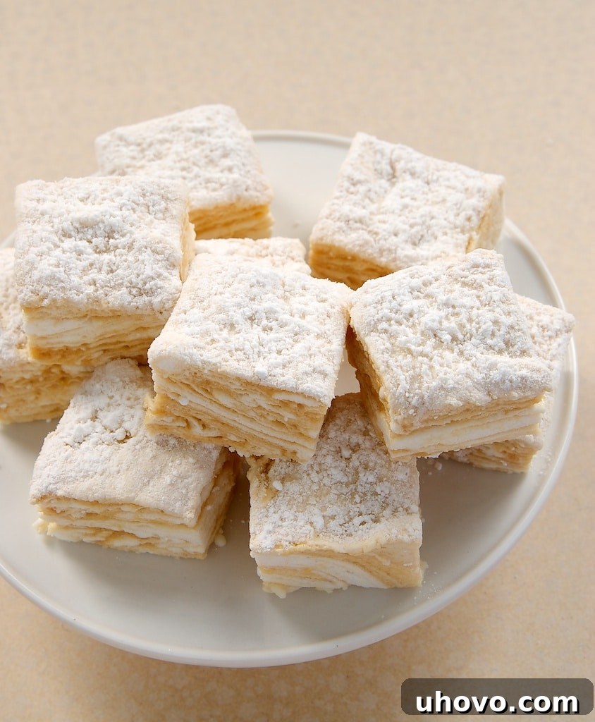 Salted Caramel Swirl Marshmallows stacked on a white pedestal, showcasing their beautiful swirl pattern.