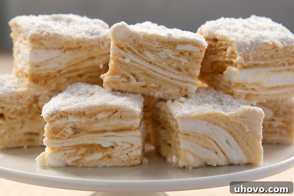 Close-up of Salted Caramel Swirl Marshmallows on a white pedestal, highlighting their soft texture.