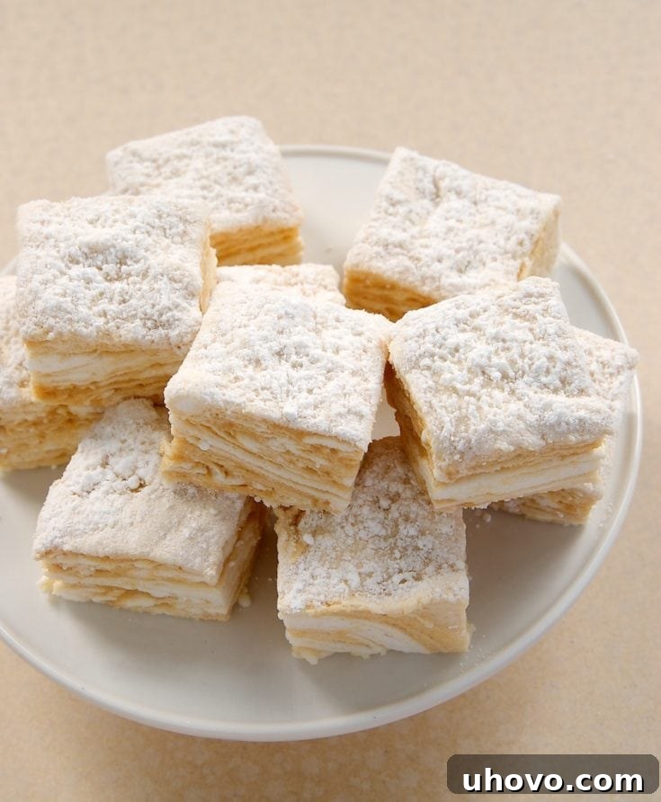 Salted Caramel Swirl Marshmallows stacked on a white pedestal, ready to be enjoyed.