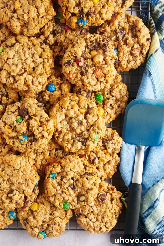 Overhead view of monster cookies cooling on a wire rack, ready for storage or serving.