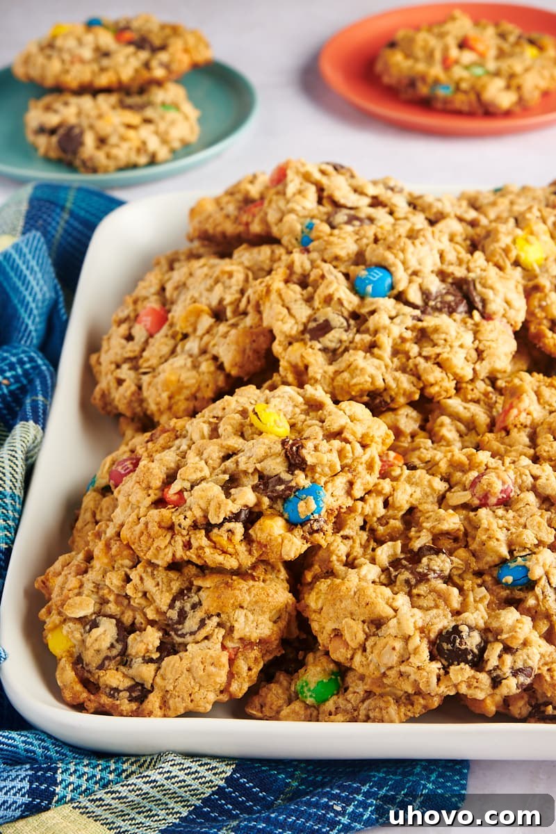A tray filled with freshly baked monster cookies, showcasing their perfect round shape and colorful toppings.