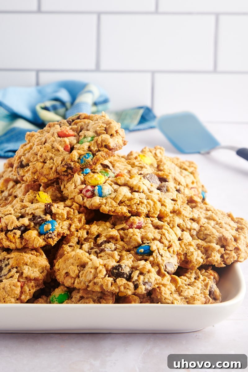 Tray of stacked monster cookies, highlighting their golden-brown edges and soft centers.