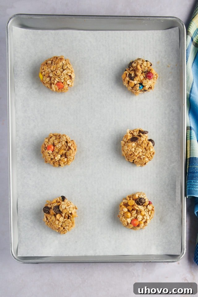 Overhead view of cookie dough portions neatly arranged on a baking sheet, with ample space between them.