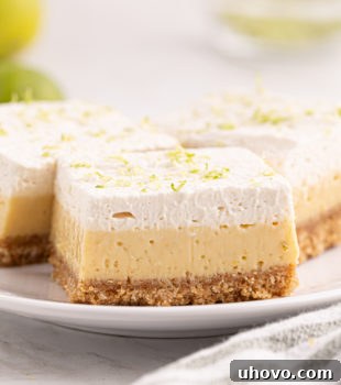 three key lime pie bars on a white plate