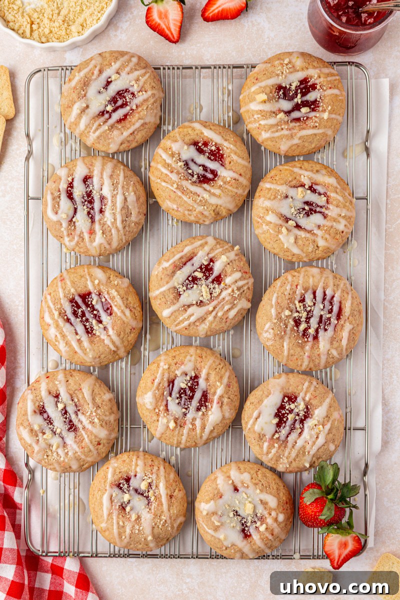 overhead view of strawberry shortcake cookies filled with strawberry jam and topped with glaze and cookie crumbs