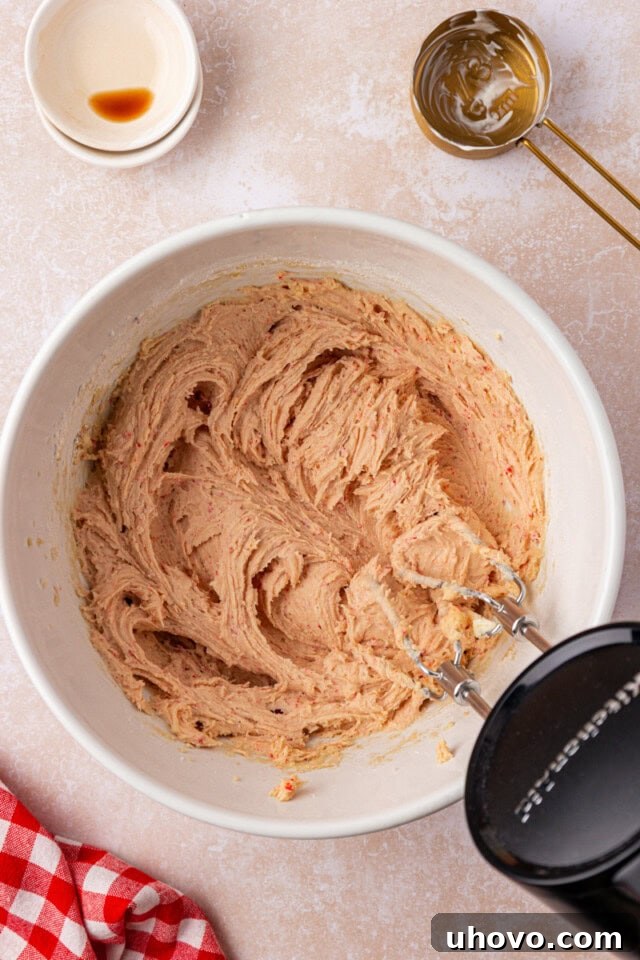 overhead view of strawberry cookie dough in a mixing bowl