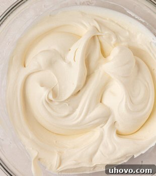 closeup view of soft, creamy mascarpone whipped cream in a glass bowl