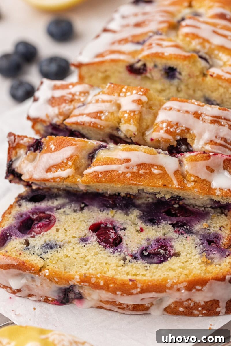partially sliced blueberry ricotta cake topped with lemon glaze