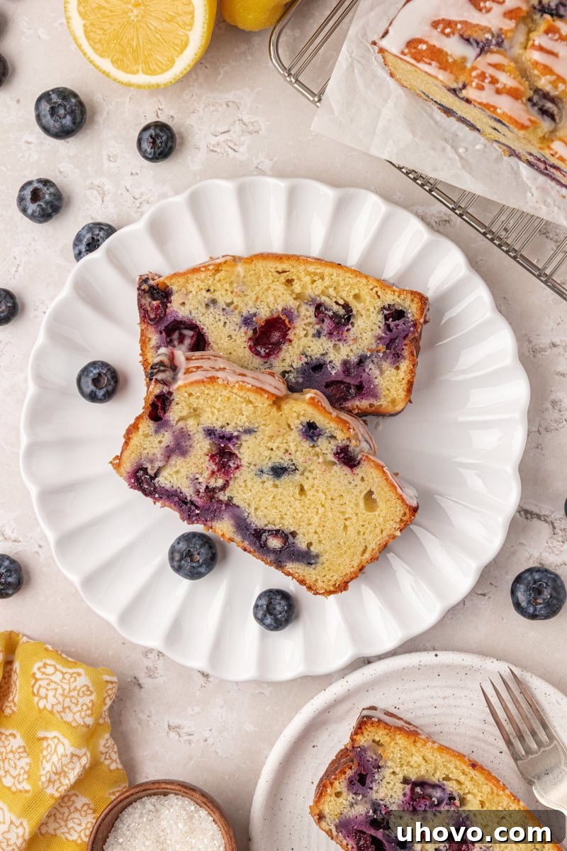 overhead view of two slices of blueberry ricotta loaf cake on a plate
