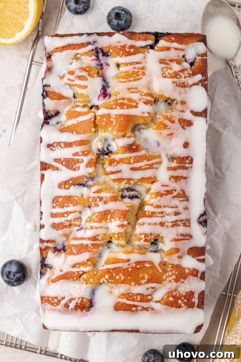 overhead view of blueberry ricotta loaf cake topped with a lemon glaze