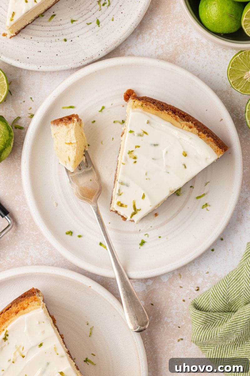 Creamy Key Lime Cheesecake Recipe: Zesty No-Bake Dessert 10 overhead view of a slice of Key lime cheesecake with a bite on a fork