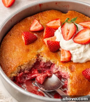 Strawberry Spoon Cake Recipe: Quick No-Bake Dessert for Summer 13 strawberry spoon cake with a scoop missing to show the juicy strawberry layer underneath a soft cake