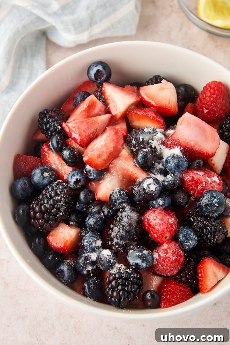 Macerated Berries Recipe: Sweetened Berry Topping for Desserts 4 fresh mixed berries with sugar and lemon juice added before stirring to macerate