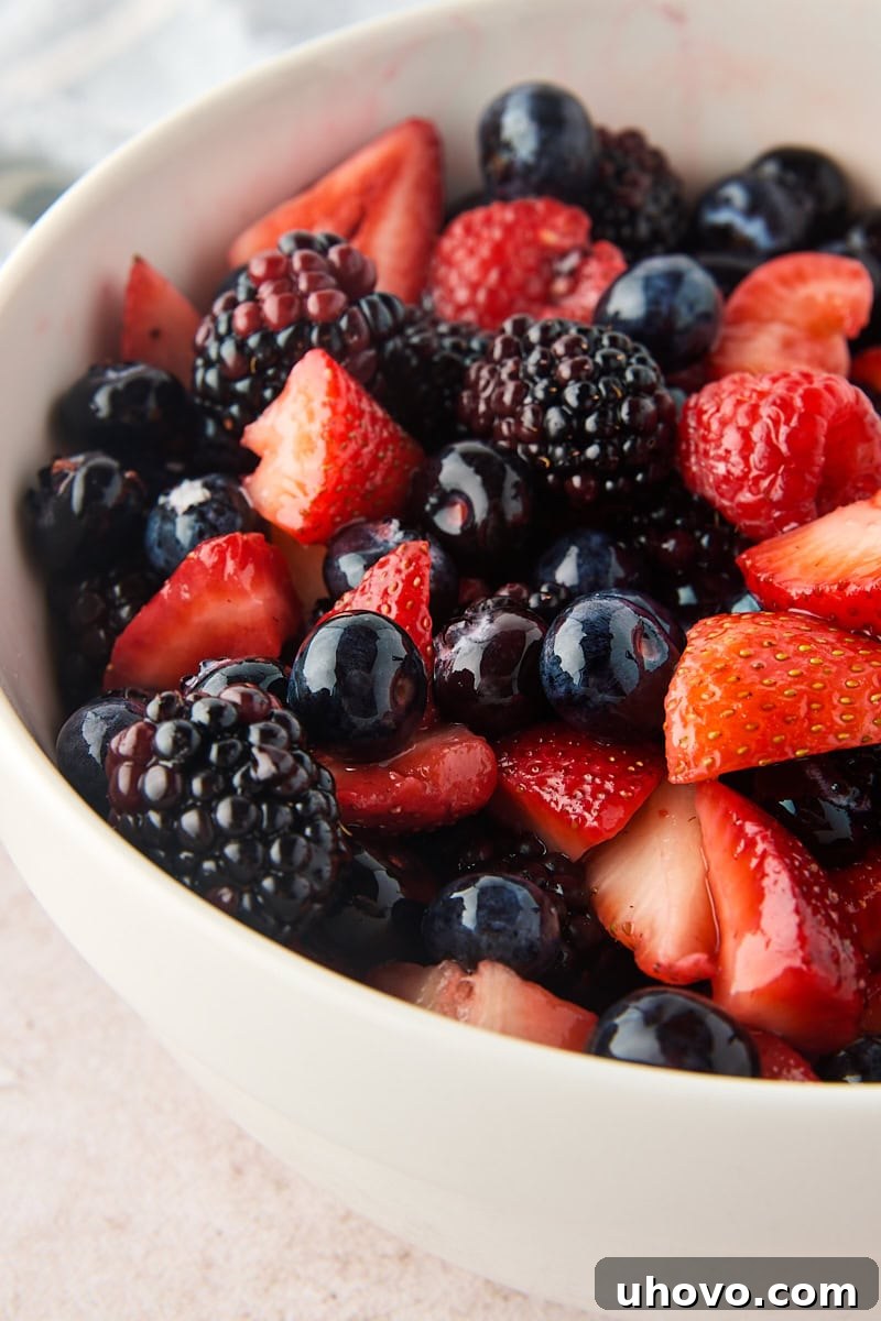 Macerated Berries Recipe: Sweetened Berry Topping for Desserts 5 macerated mixed berries in a white bowl