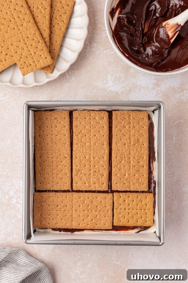 No-Bake S'mores Icebox Cake 6 a layer of graham crackers on top of marshmallow filling and chocolate ganache