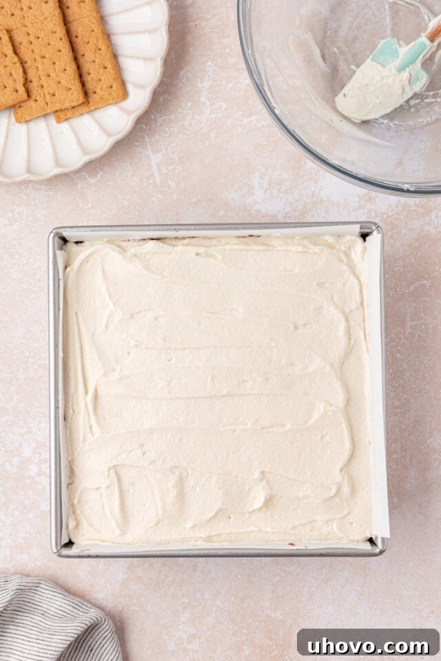 No-Bake S'mores Icebox Cake 7 s'mores icebox cake assembled in a square pan ready to go into the refrigerator