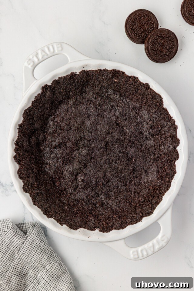 No-Bake Chocolate Chip Icebox Pie Recipe 4 overhead view of Oreo cookie crust in a white pie pan
