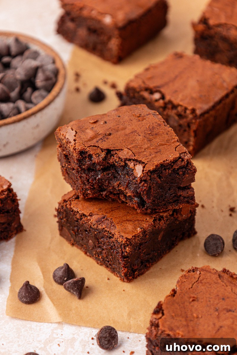 Fudgy Brownies Made with Brown Butter 11 stack of two brown butter brownies with a bite missing from the top to show the fudgy interior