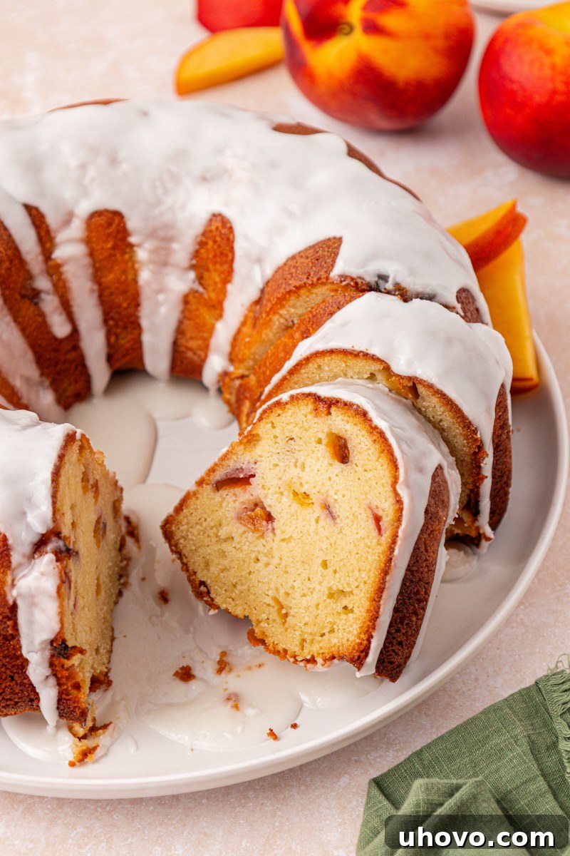 Peach Pound Cake Recipe with Fresh Peaches 2 partially sliced peach pound cake topped with an almond glaze