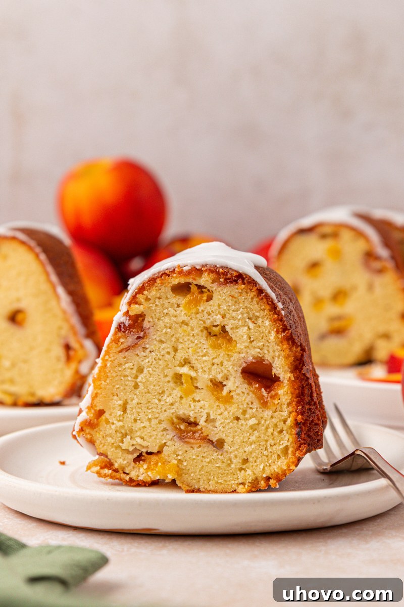 Peach Pound Cake Recipe with Fresh Peaches 10 a slice of peach pound cake filled with fresh peaches and topped with an almond glaze