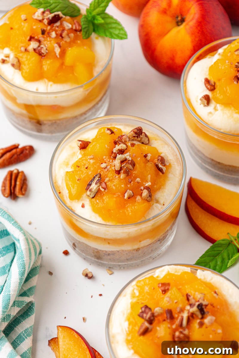 no-bake peach cheesecake jars garnished with toasted pecans