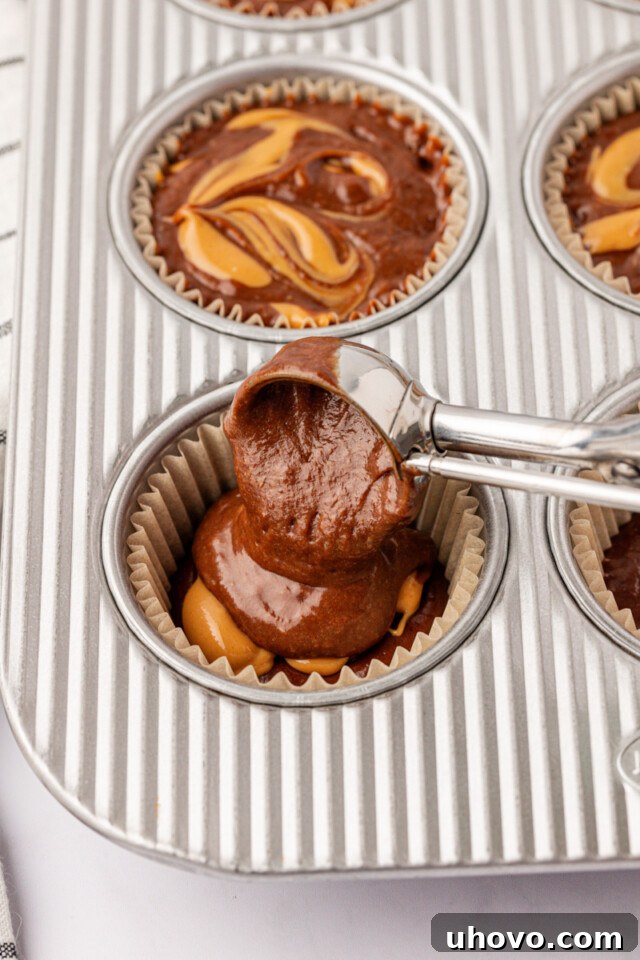 Homemade Chocolate Peanut Butter Swirl Muffins 6 assembling chocolate peanut butter swirl muffins in a muffin pan