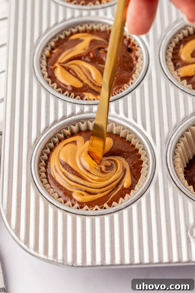 Homemade Chocolate Peanut Butter Swirl Muffins 7 warmed peanut butter being swirled into chocolate muffin batter