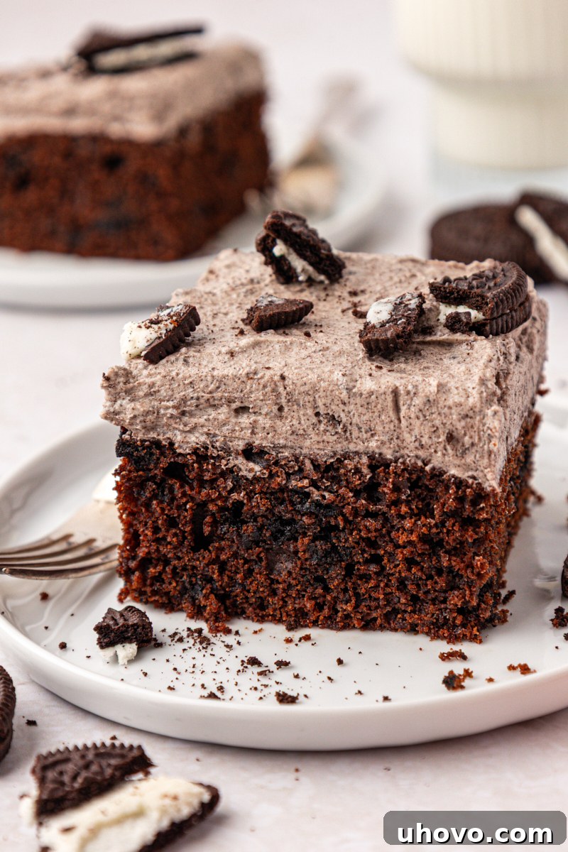 Decadent Oreo Sheet Cake with Creamy Oreo Frosting 2 close up of a slice of chocolate Oreo cake with cookies and cream buttercream frosting