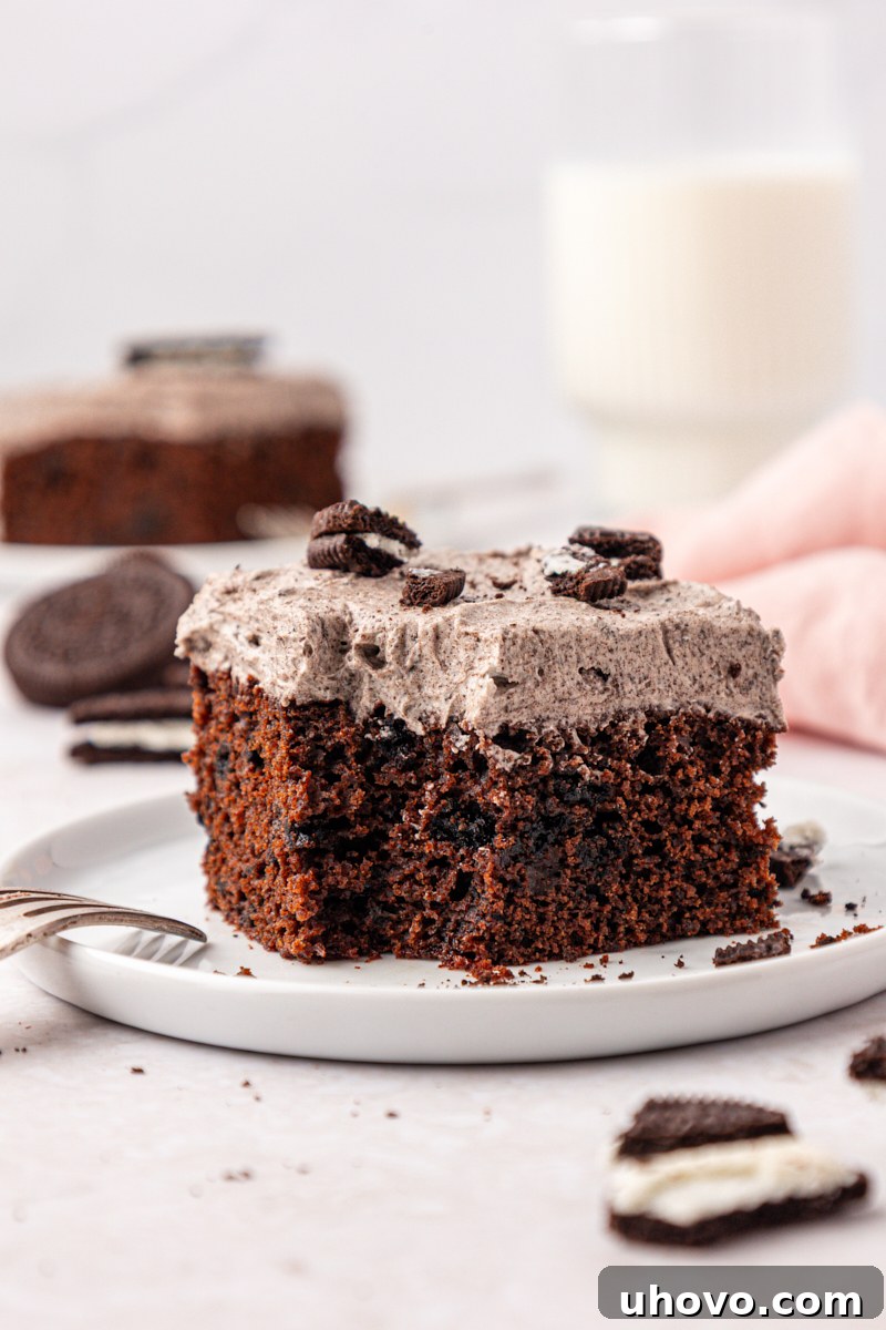 Decadent Oreo Sheet Cake with Creamy Oreo Frosting 12 a slice of chocolate Oreo sheet cake with a bite missing