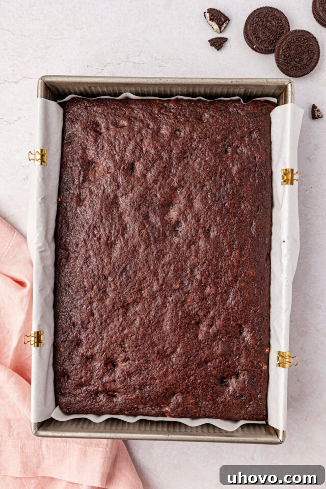 Decadent Oreo Sheet Cake with Creamy Oreo Frosting 8 freshly baked chocolate Oreo cake in a 9x13 baking pan