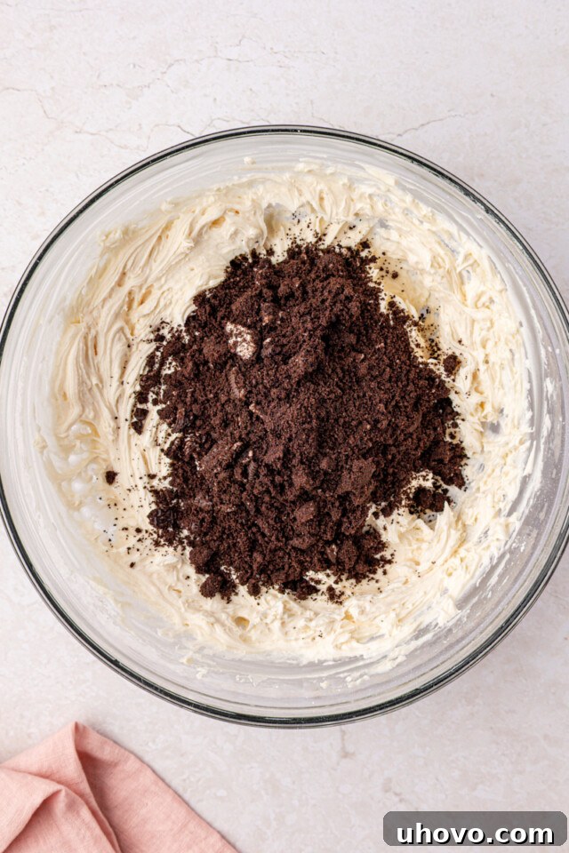 Decadent Oreo Sheet Cake with Creamy Oreo Frosting 9 Oreo cookie pieces added to buttercream frosting