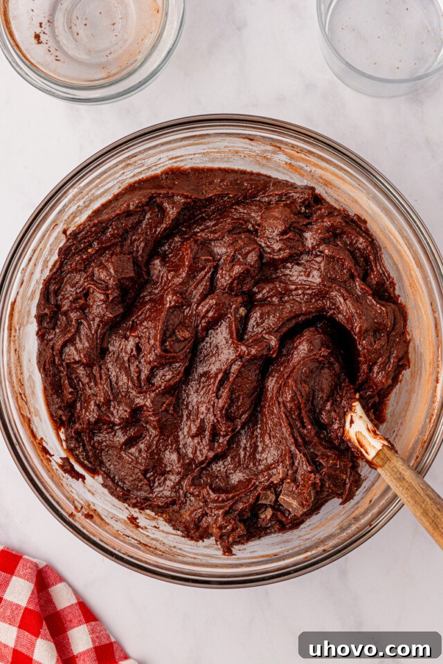 brownie batter in a glass mixing bowl