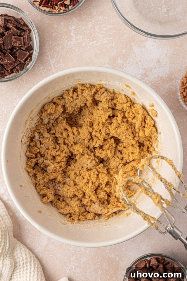 Gooey Loaded Chocolate Chip Cookies 5 overhead view of cookie dough in a mixing bowl