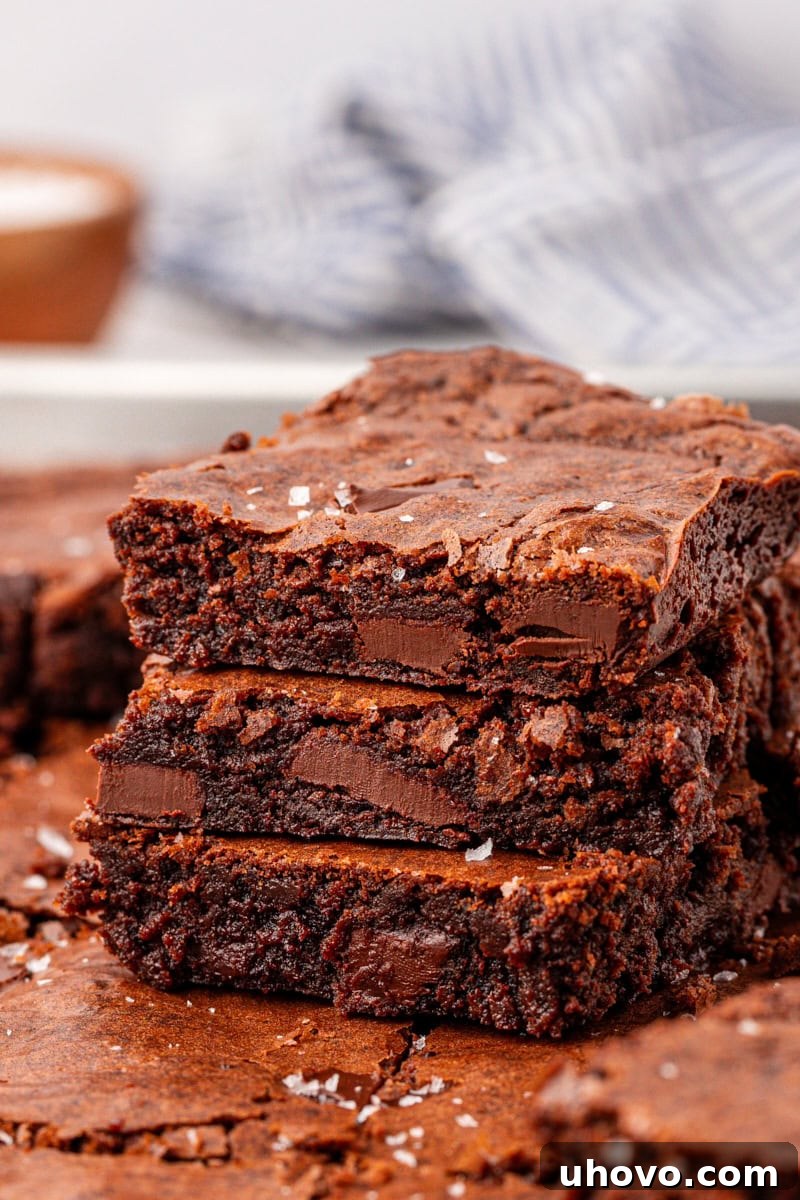 stacked chocolate brownies with fudgy centers, chewy edges, and crackly tops