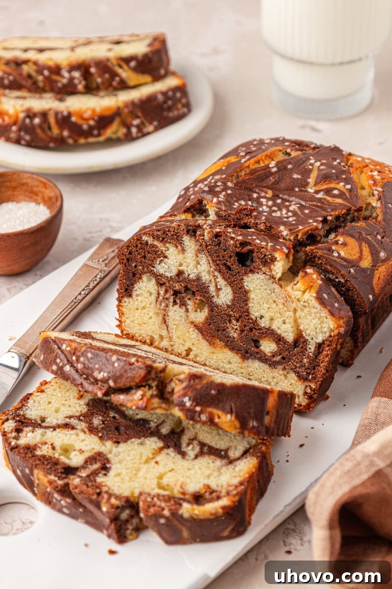 Classic Marble Loaf Cake Recipe 2 partially sliced marble loaf cake with chocolate and vanilla swirls