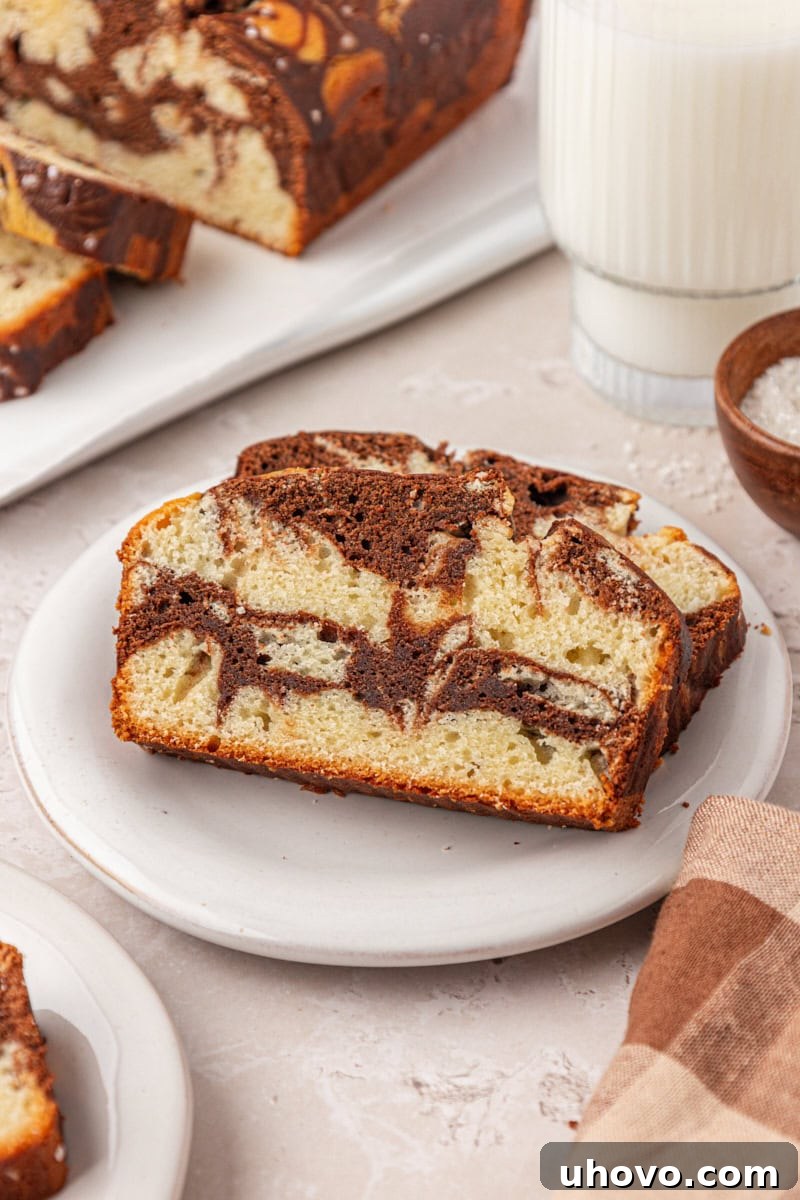 Classic Marble Loaf Cake Recipe 12 two slices of marble loaf cake on a white plate