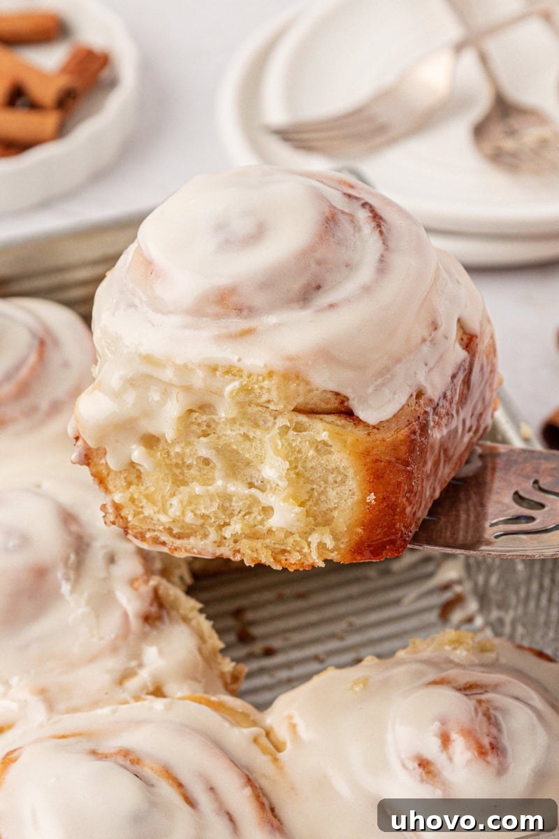 Overnight Cinnamon Roll Recipe for Fluffy Morning Pastry 2 a soft, fluffy cinnamon roll topped with tangy cream cheese frosting