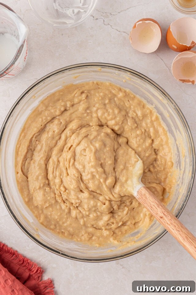 cinnamon muffin cake batter in a glass mixing bowl