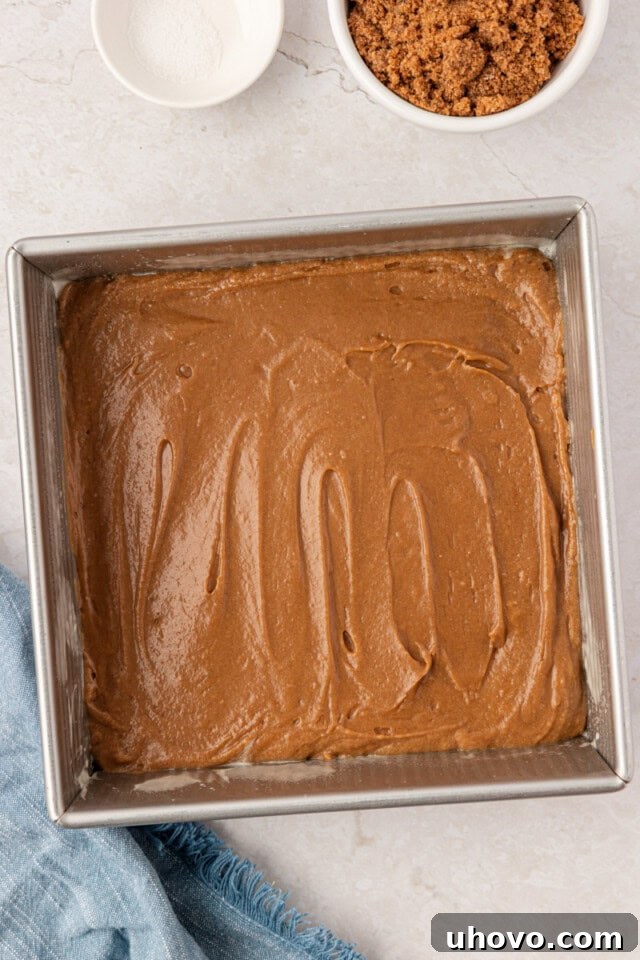 butterscotch cake batter spread in a square baking pan