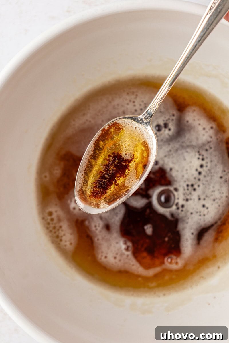 a spoonful of brown butter showing the amber color and browned milk solids