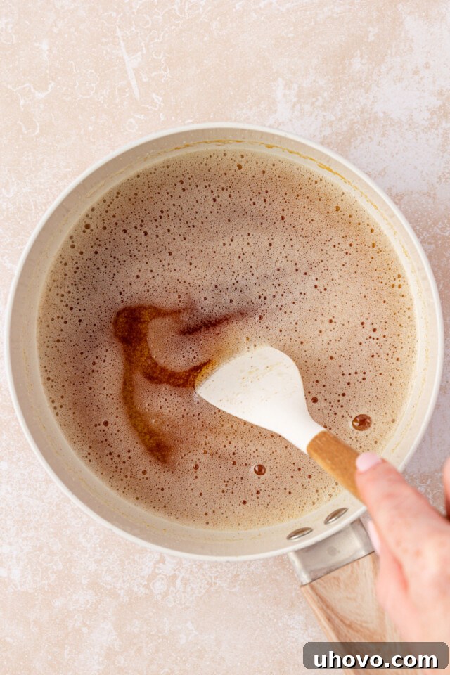 browned butter being stirred in a saucepan